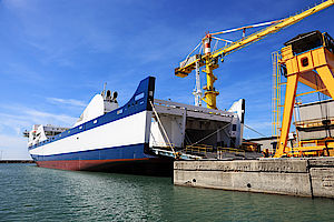 crane loading items onto large boat 