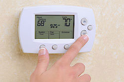 hand adjusting air conditioning controls